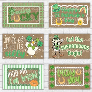 May include: A collection of St. Patrick's Day themed cards. The cards feature phrases like "Feeling Lucky," "Kiss Me I'm Irish," and "Let the Shenanigans Begin!" with images of a horseshoe, shamrocks, and a cartoon character.