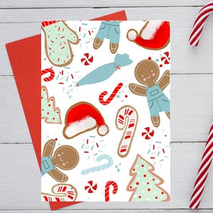 May include: A Christmas-themed greeting card with a festive pattern of gingerbread cookies, candy canes, Santa hats, and sprinkles on a white background. A red envelope is visible behind the card, with a candy cane on the right.