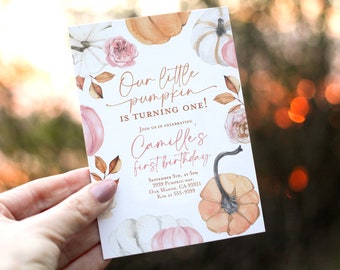May include: A white invitation card with a watercolor design of pumpkins and flowers. The text on the card reads "Our little pumpkin is turning one! Join us in celebrating Camille's first birthday. September 5th, at 5pm, 3939 Pumpkin Way, Oak Manor, CA 93921, Kim at 555-9399."