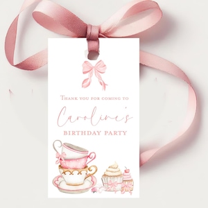 May include: Pink and white teacup and cupcake party favor tag with the text "Thank you for coming to Caroline's Birthday Party".