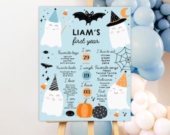 Puede incluir: Un cartel de hitos del primer cumpleaños de Halloween azul y naranja con un fantasma, un murciélago y una calabaza. El cartel enumera la edad, la altura, el peso, los juguetes, los libros, las canciones y las primeras palabras favoritas de Liam.