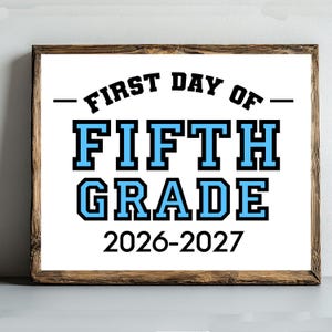 May include: A rectangular sign in a dark wood frame featuring the black text FIRST DAY OF, the large light blue text FIFTH GRADE, and the black text 2026-2027 on a white background. The design uses a bold, block-style font for the grade level.