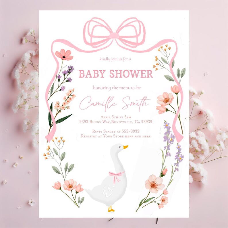 May include: A pink and white baby shower invitation with a floral border and a white goose with a pink bow. The invitation says "kindly join us for a baby shower honouring the mom-to-be Camille Smith" and includes the date, time, and location of the event.