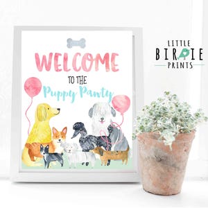 May include: A white framed sign with the text "Welcome to the Puppy Party" in colorful lettering. The sign features a watercolor illustration of a group of dogs, including a golden retriever, a dachshund, a poodle, and a terrier. There are two pink balloons in the background.