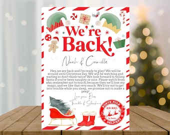 May include: A red and white Christmas card with a message from the elves, "We're Back!"  The card features a cartoon image of two elves, a gingerbread man, and a sleigh with a Christmas tree. The card is addressed to Noah & Camille.