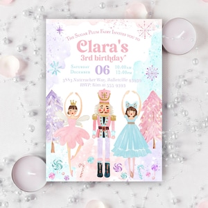 May include: A rectangular birthday invitation card featuring watercolor illustrations of a fairy, a nutcracker, and a dancer. The text reads: The Sugar Plum Fairy invites you to Clara's 3rd birthday, Saturday December 06, 10:00am-12:00pm, 3883 Nuteracker Way, Balletville 93939, RSVP: Kim at 555-9393.