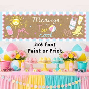 May include: A rectangular banner with a brown background and a scalloped pink border featuring the text Madisyn is Two cool, a yellow sun, ice cream, a beach ball, a swimsuit, sunscreen, and a beach chair, measuring 61 cm by 183 cm.