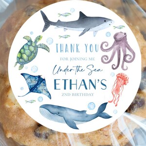 May include: Round sticker with a white background and blue and green watercolor illustrations of sea creatures. The text "Thank You for joining me Under the Sea Ethan's 2nd Birthday" is printed on the sticker.