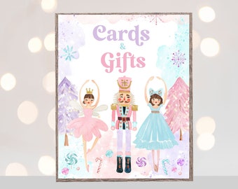 May include: A printable sign with a watercolor background featuring a Nutcracker, a ballerina in a pink tutu, and a ballerina in a blue tutu. The sign says "Cards & Gifts" in purple text.