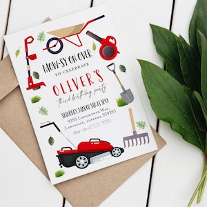 May include: A white invitation card with red and green illustrations of lawn care tools. The text on the card reads "Mow-sy on over to celebrate Oliver's third birthday party. Saturday, March 5th at 3pm. 9393 Lawnmower Way, Lawnville, Alabama 939393.  RSVP 4555-9393."