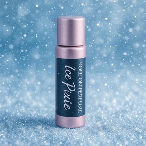 May include: A metallic pink roll-on perfume bottle. The label is dark blue with the words "Ice Pixie" in white script and "Roll-on Perfume" in a smaller font. The background is a blurred blue with white specks, resembling snowflakes.