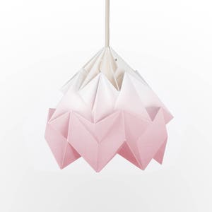 May include: A pink and white ombre origami-style pendant light. The light is made of paper and has a geometric design.