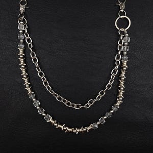 May include: Silver wallet chain with two layers of chain and decorative beads. The chain has two clasps for attachment. The bottom of the image has the text "ONE-77 ORIGINAL DESIGN".