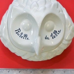 May include: White ceramic owl-shaped box with blue lettering that reads "Poubelle de Table".
