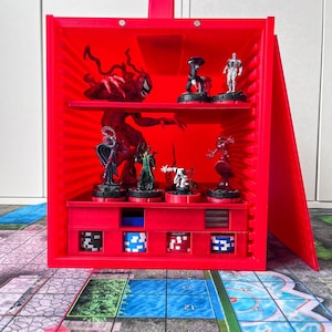May include: A bright red, open-faced display case with multiple shelves, holding miniature figurines and game pieces. The case is designed to store and showcase collectibles. The case is open, revealing the contents inside. The case is sitting on a game board.