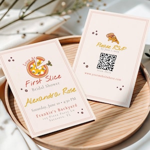 May include: Two light pink bridal shower invitations with a pizza slice graphic. One invitation reads "First Slice Bridal Shower" with the name "Alexandra Rose" and event details. The other says "Please RSVP" with a QR code.