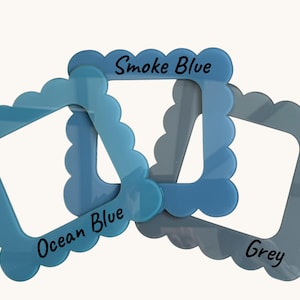 May include: Three decorative frames in shades of blue and grey. The frames have a scalloped edge and square center. The text "Smoke Blue", "Ocean Blue", and "Grey" are printed on the frames.