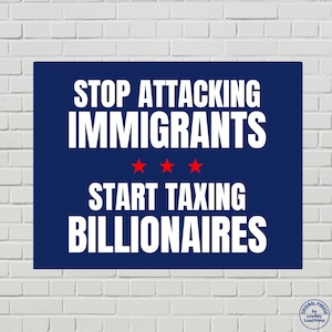 May include: A navy blue rectangular sign with white text that reads "STOP ATTACKING IMMIGRANTS" above three red stars and "START TAXING BILLIONAIRES." The sign is against a white brick wall.