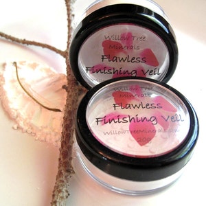 May include: Two clear plastic containers with black lids containing a white powder. The lids have a pink floral design and the text "Willow Tree Minerals Flawless Finishing Veil" printed on them.