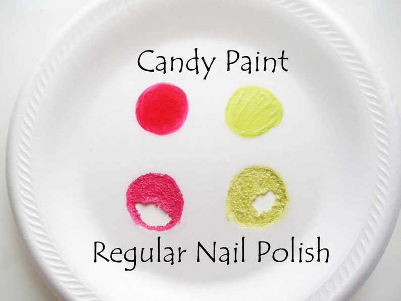 May include: A white plate with four samples of nail polish. Two samples are labeled "Candy Paint" and are a bright red and a light green. The other two samples are labeled "Regular Nail Polish" and are a darker pink and a light green.
