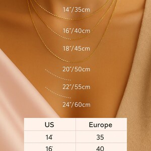 May include: A selection of gold-coloured necklaces, ranging from 14 inches (35cm) to 24 inches (60cm) in length. The image includes a chart showing US and European necklace size conversions. The necklaces are shown on a person.