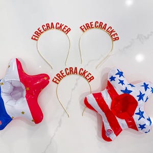 May include: Patriotic-themed party decorations. Two star-shaped inflatables in red, white, and blue, and three headbands with the word "FIRECRACKER" in red. Perfect for Independence Day celebrations.