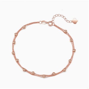 18K rose gold Starry Sky double row beaded bracelet on white background