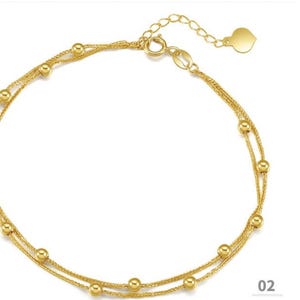 18K yellow gold Chopin chain bracelet with evenly spaced beads flat lay