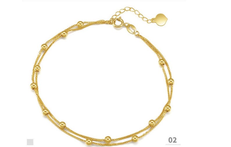 18K yellow gold Chopin chain bracelet with evenly spaced beads flat lay