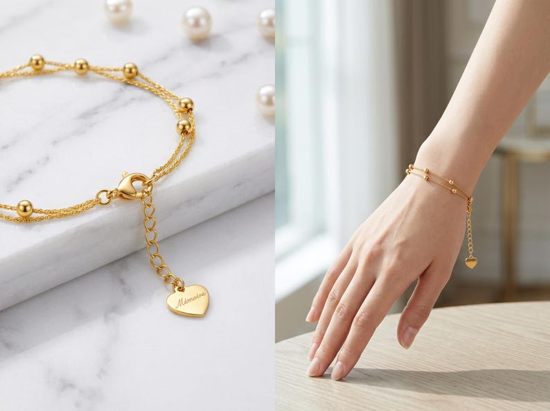 Elegant woman's hand wearing 18K gold bracelet on white marble desk