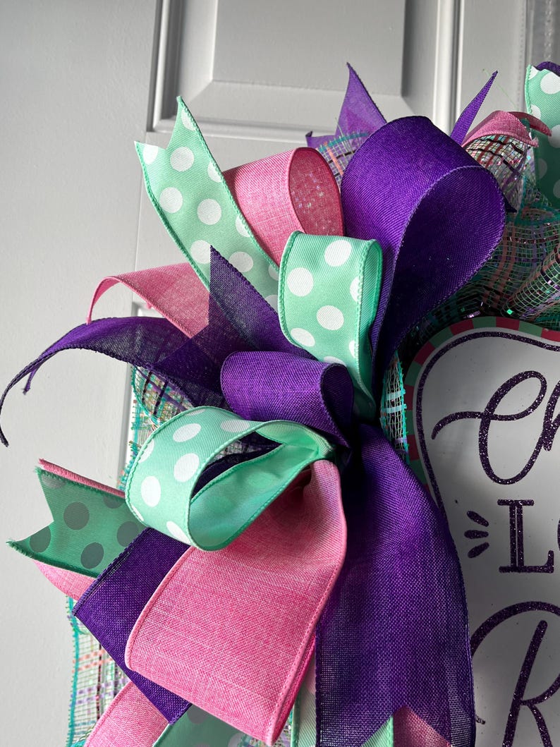 May include: A white ceramic mug with a black handle and the text "But First, Coffee" in a black, handwritten-style font. The mug is on a white surface.