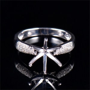 This Solitaire Engagement Ring Semi-Set can fit a 10mm round cut center stone, accented with small Moissanite diamonds.