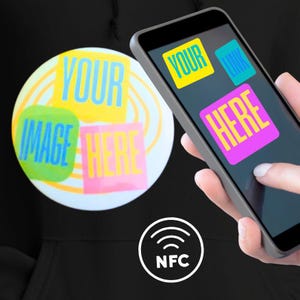 May include: A black hoodie with a white NFC symbol. A smartphone displays the words "YOUR LINK HERE" and a circular design with the words "YOUR IMAGE HERE". The design has yellow, blue, and pink text.