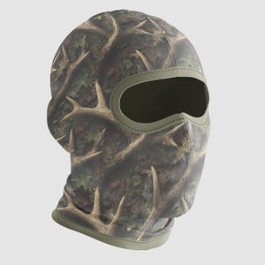 May include: A camouflage balaclava with a brown and green antler pattern. The balaclava has a large eye opening and a green trim around the face opening. The fabric has a forest-like pattern.