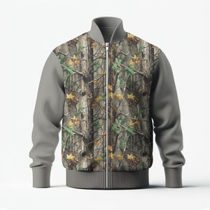 May include: A camouflage bomber jacket with a full-zip closure. The jacket features a woodland camouflage pattern on the front and back panels, with gray sleeves, collar, and hem. The jacket is designed with a ribbed collar, cuffs, and hem.