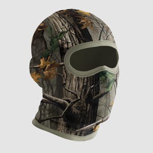 May include: A camouflage balaclava with a woodland pattern featuring brown, green, and tan hues. The balaclava has an oval eye opening and a light green trim. The fabric design mimics tree bark and fallen leaves.