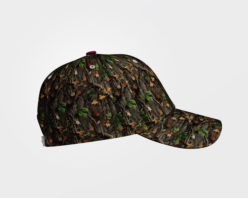 May include: A camouflage baseball cap with a curved brim. The cap features a pattern of brown, green, and tan leaves and branches. The top button is a dark red color.