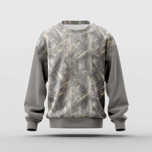 May include: A gray sweatshirt with a camouflage pattern on the torso and a solid gray color on the sleeves. The camouflage design features a mix of brown, gray, and tan colors, resembling a forest scene.
