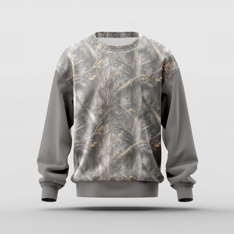 May include: A gray sweatshirt with a camouflage pattern on the torso and a solid gray color on the sleeves. The camouflage design features a mix of brown, gray, and tan colors, resembling a forest scene.