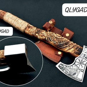 May include: A handcrafted axe with a wooden handle wrapped in twine. The axe head is silver with etched designs and the text "QLYGAD". Includes a leather sheath. The axe is a tool.
