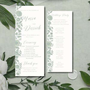 May include: A wedding stationery set comprising a program and a wedding party list. The design incorporates floral accents in a soft green shade. The program includes the names Maria and Derrick, the date, and ceremony details.