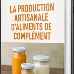 May include: A book with the title "LA PRODUCTION ARTISANALE D'ALIMENTS DE COMPLÉMENT" in orange text. Three glass jars with white lids are in front of the book. One jar contains an orange liquid, another a tan powder, and the third a white liquid.