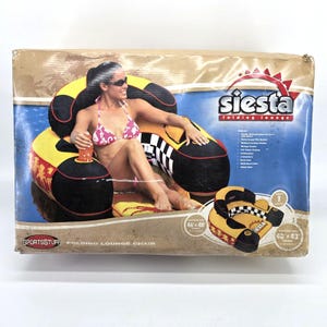 May include: A Sportsstuff Siesta folding lounge chair in a box. The inflatable chair is yellow, black, and white with a checkered pattern. The box displays dimensions of 46 inches by 48 inches deflated and 40 inches by 43 inches inflated.