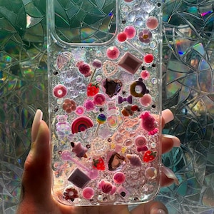 Junk phone case, charms, glitter, and jewels.