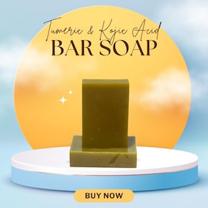 May include: A green bar soap is displayed on a white and blue platform against a yellow backdrop. The text "Turmeric & Kojic Acid BAR SOAP" is at the top. A button at the bottom reads "BUY NOW".