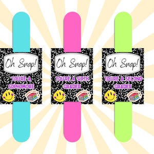 May include: Three colorful bookmarks with the text "Oh Snap!" and grade-specific messages: "You're a Sophomore," "You're a Sixth Grader," and "You're a Second Grader." Each bookmark features a smiley face and book graphic.