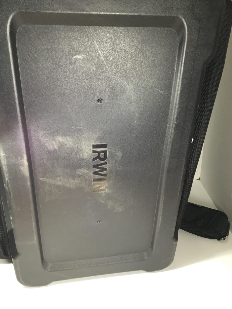 May include: A black, rectangular tool bag with the brand name "IRWIN" printed in silver. The bag has a textured surface and a black strap. The image is taken from a low angle.