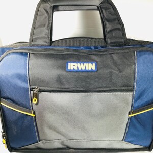 May include: A blue, gray, and black IRWIN tool bag with a black handle. The bag has a zippered main compartment and several exterior pockets. The IRWIN logo is displayed on the front of the bag. Yellow accents are visible on the zippers and pockets.