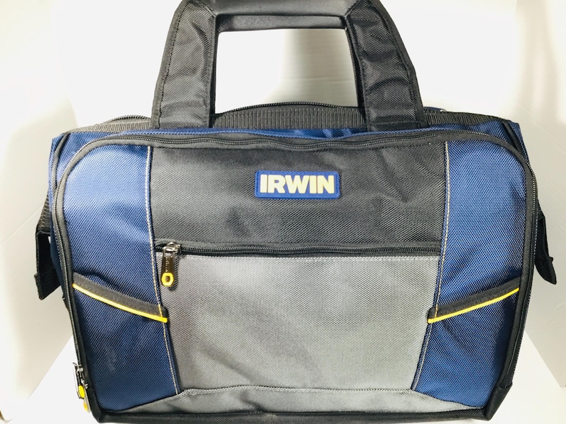 May include: A blue, gray, and black IRWIN tool bag with a black handle. The bag has a zippered main compartment and several exterior pockets. The IRWIN logo is displayed on the front of the bag. Yellow accents are visible on the zippers and pockets.