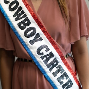 Listo para enviar en cualquier momento: la banda "Cowboy Carter" en satén blanco, rojo, cinta azul brillante